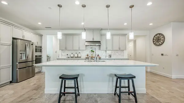 Professional photo of a bright kitchen with a large island